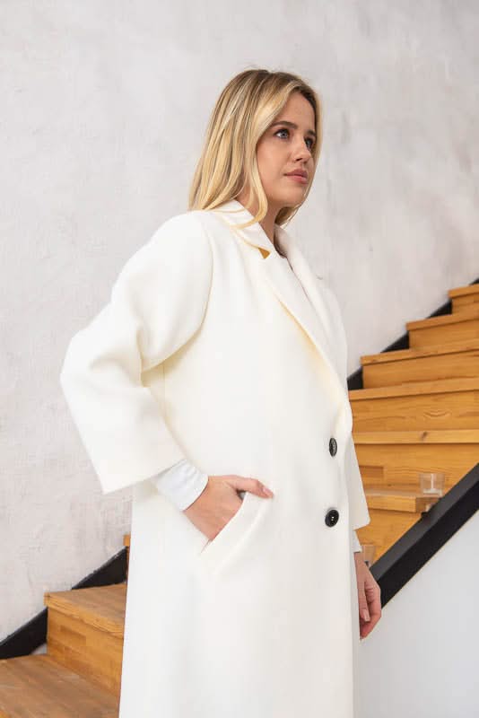 Unlined coat. Buttoned. Three-quarter sleeves. Wool and cashmere blend.