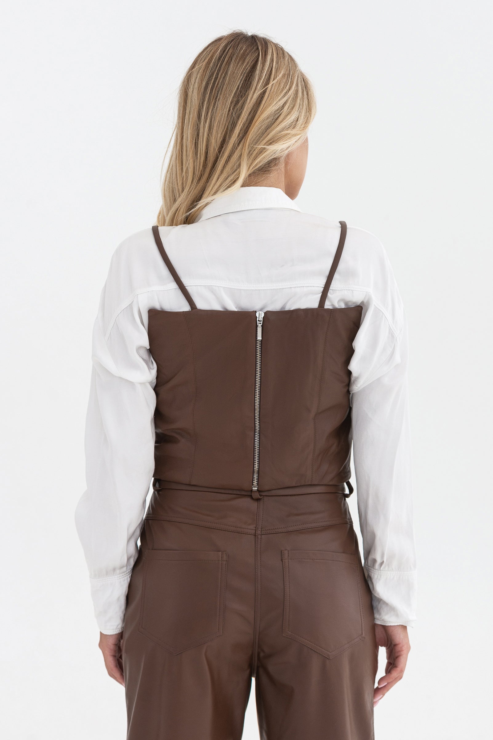 Spaghetti strap top with decorative buttons. Leather