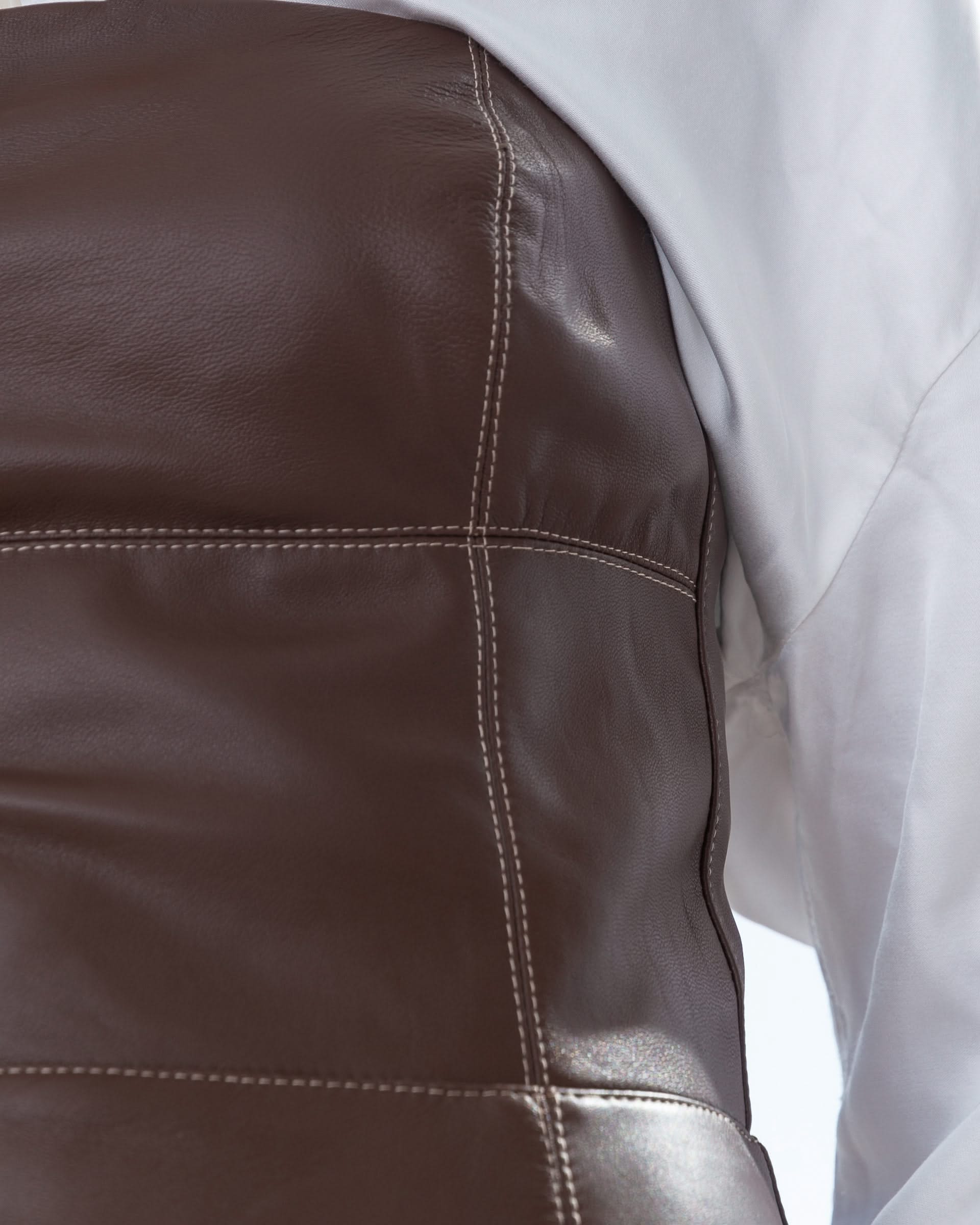 Strapless dress made of genuine leather. Adorned with decorative stitching.