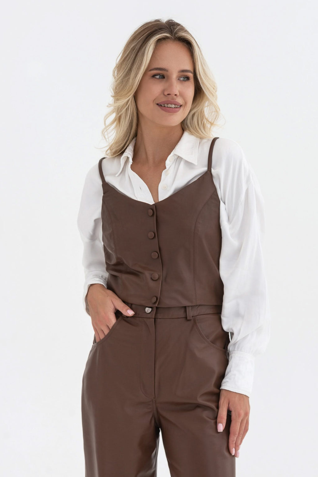 Spaghetti strap top with decorative buttons. Leather