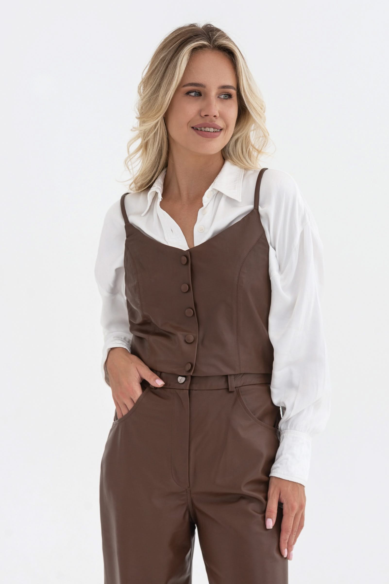Spaghetti strap top with decorative buttons. Leather