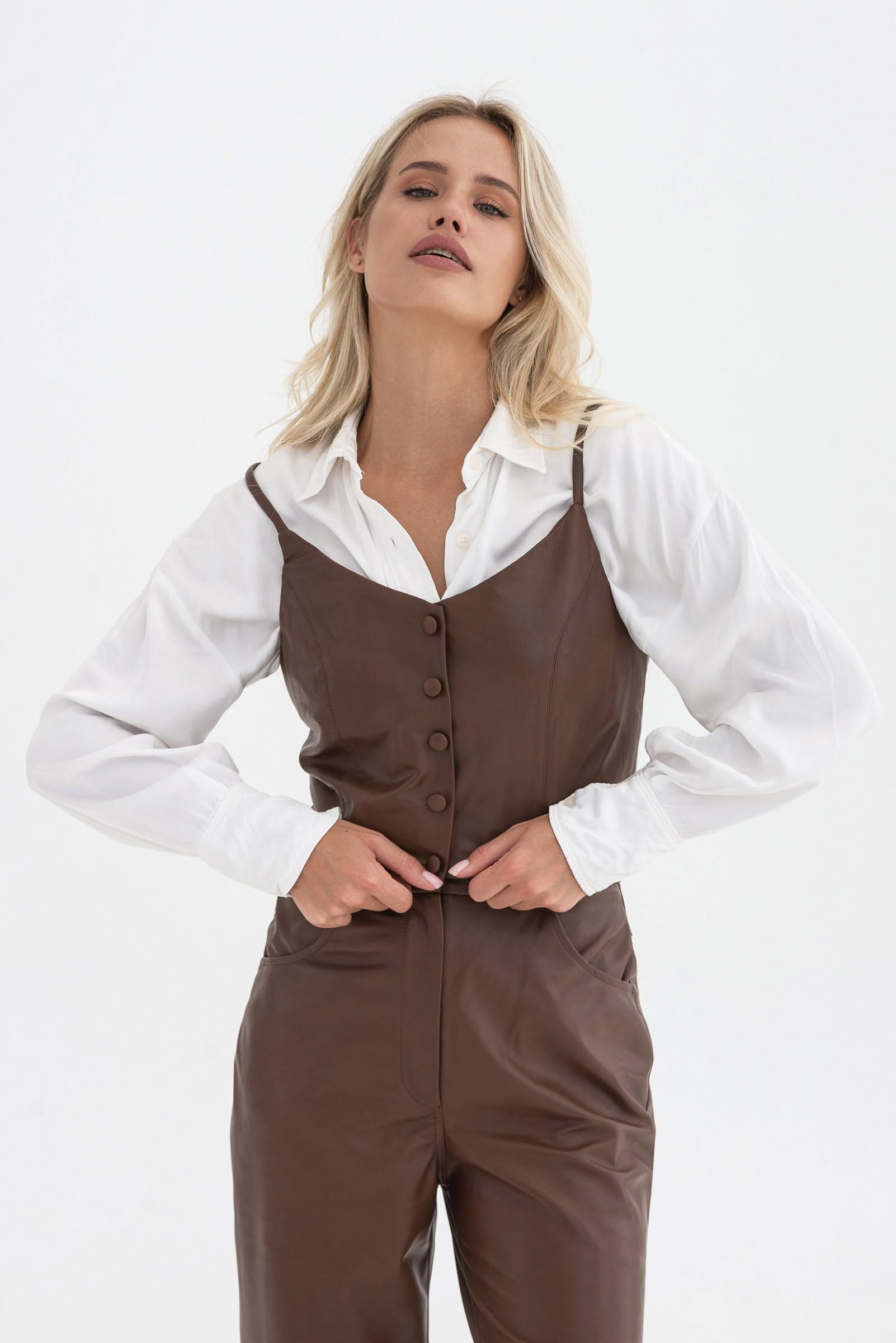 Spaghetti strap top with decorative buttons. Leather